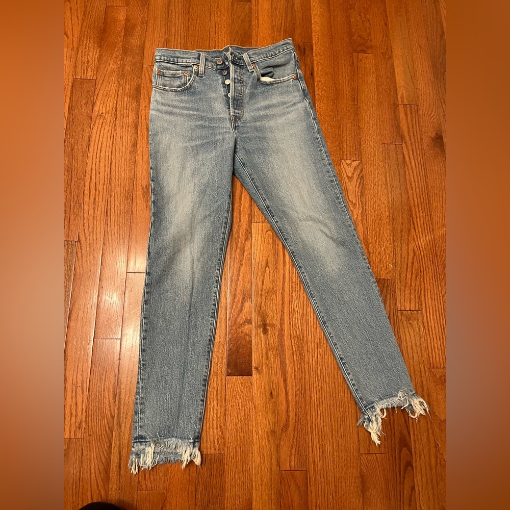 Levi’s frayed light blue jeans
